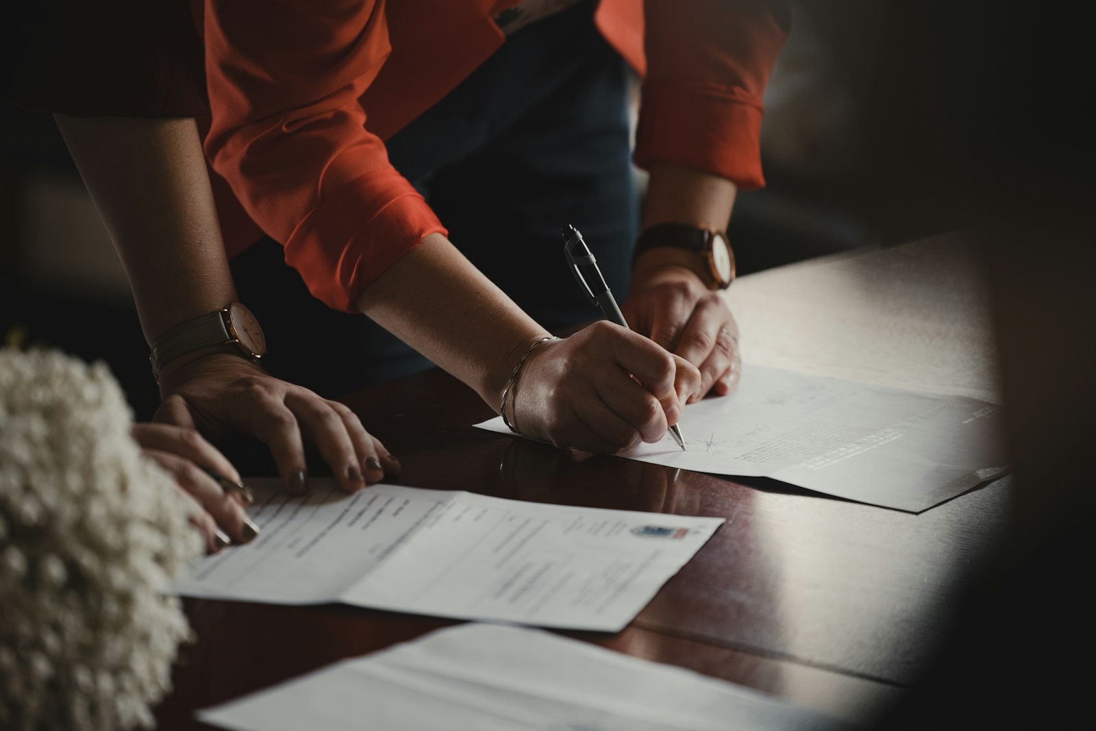 Two people signing company formation documents in Colombia